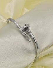 Classy silver twist nail bracelet on satin, versatile Canadian jewellery piece.
