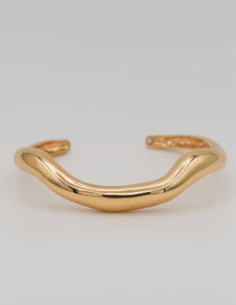Sculpted gold bangle with wave-like design